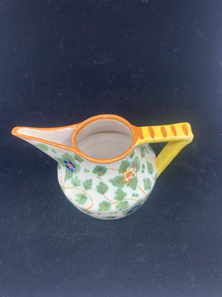 PAINTED UNIQUE PITCHER W YELLOW HANDLE.