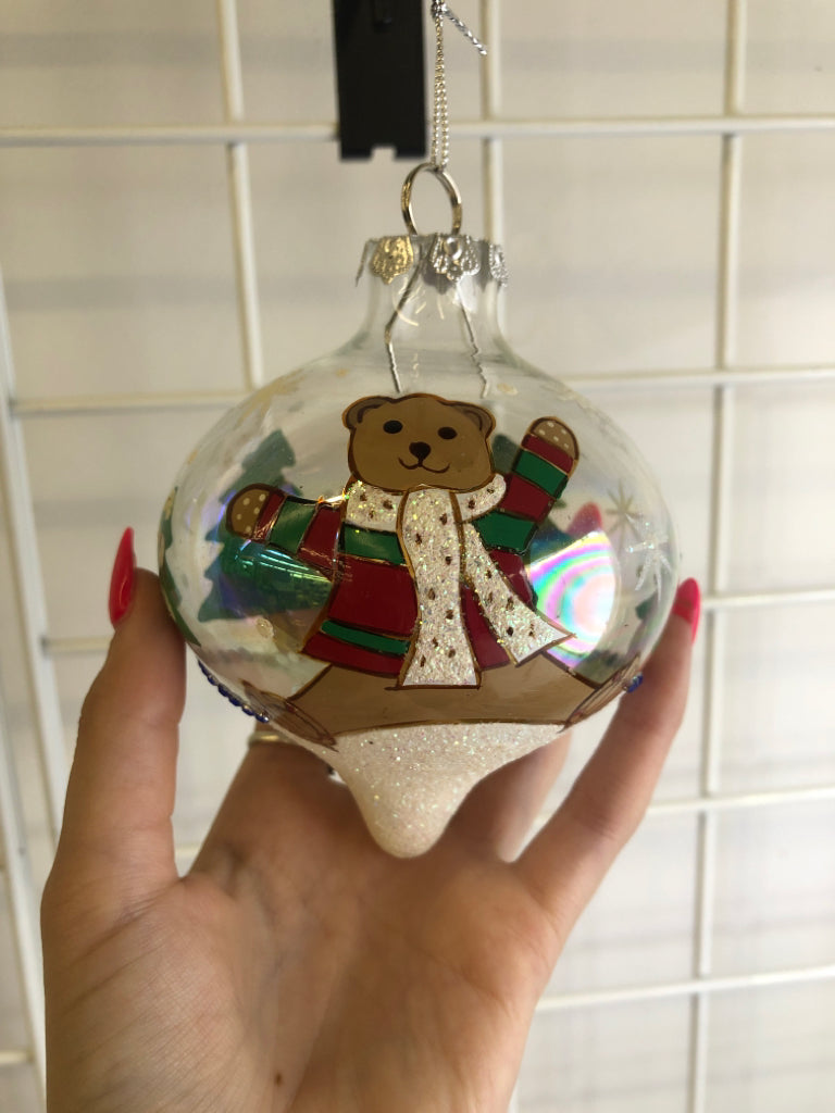 IRIDESCENT GLASS ORNAMENT W/ PAINTED TEDDY RED/GREEN SWEATER.