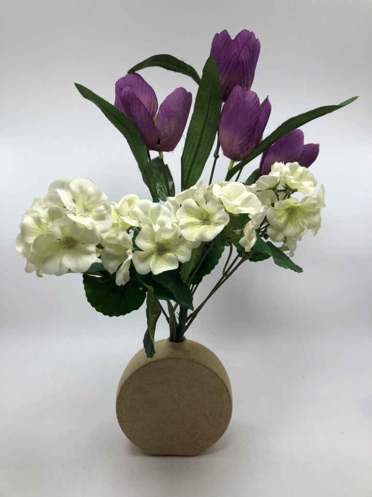 FAUX PURPLE TULIPS IN TAN ROUND VASE.