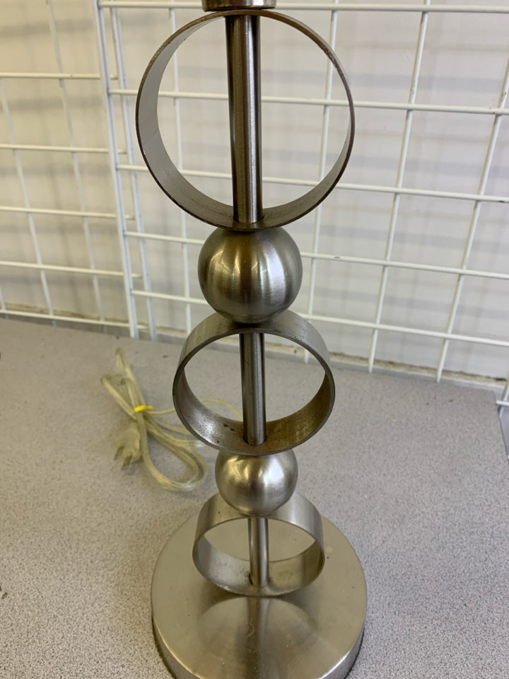 SILVER CIRCLE BASE LAMP W CREAM SHADE.