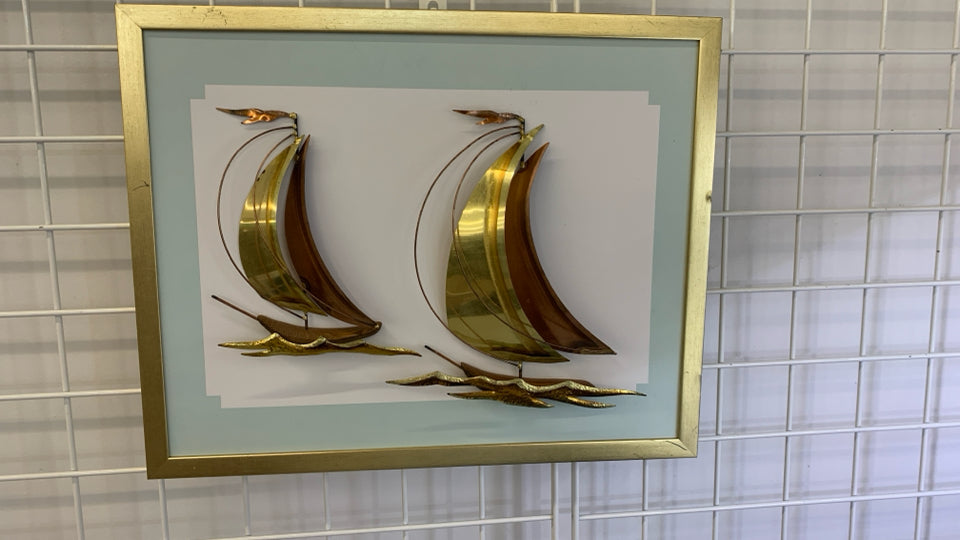 BRONZE METAL SHIPS MOUNTED ON GOLD FRAME.