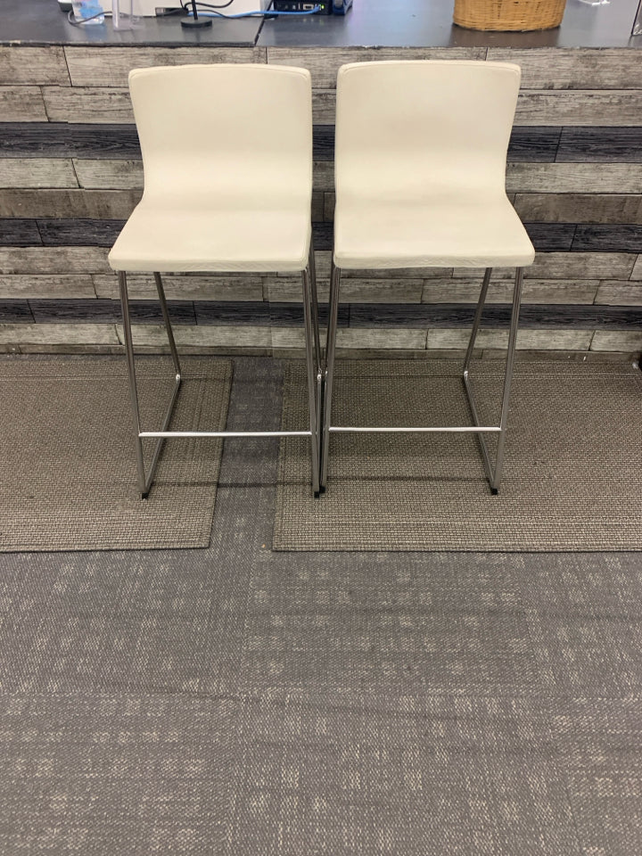 2 WHITE FAUX LEATHER STOOLS.