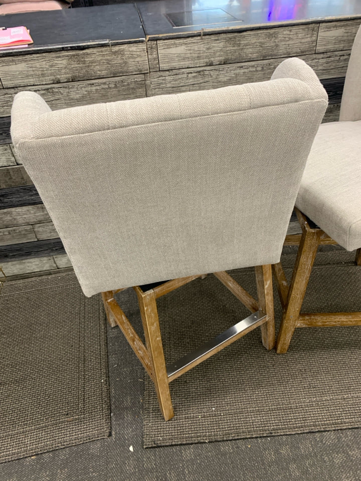 2 GRAY UPHOLSTERED SWIVEL CHAIRS.