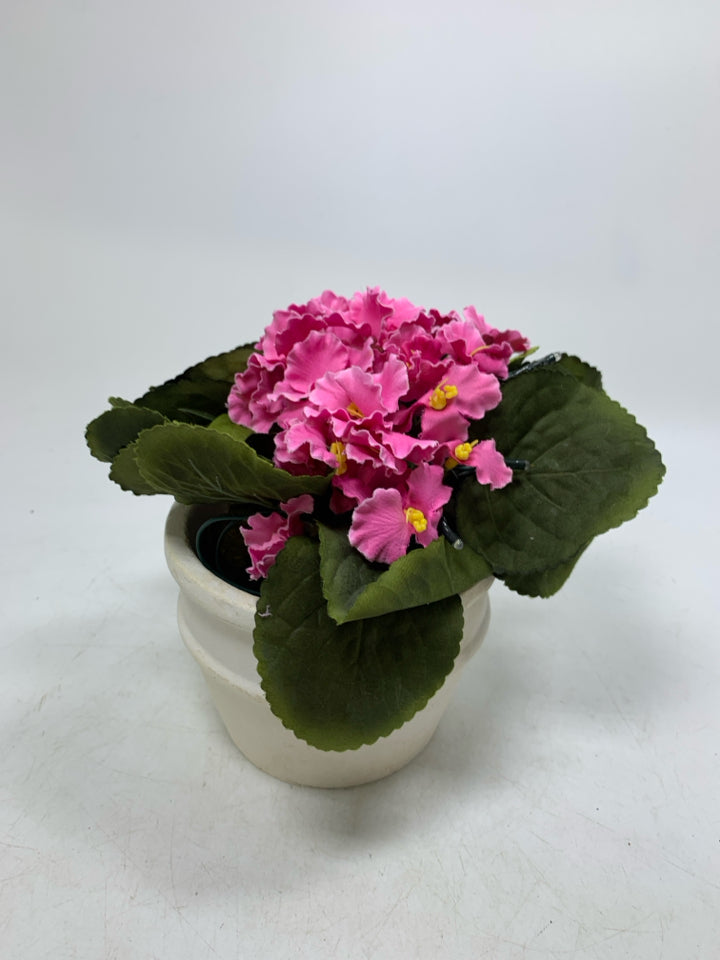 CREAM PLANTER W/ FAUX PINK FLOWERS AND LIGHTS.