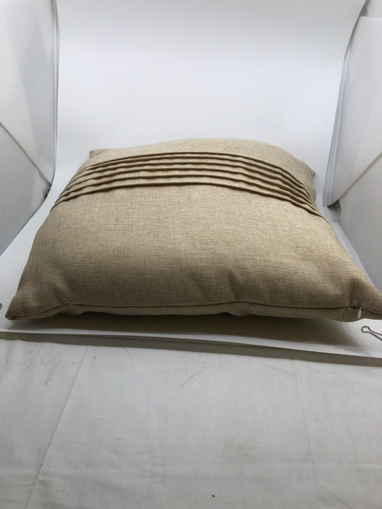 BEIGE PILLOW W/ PLEATS IN MIDDLE.