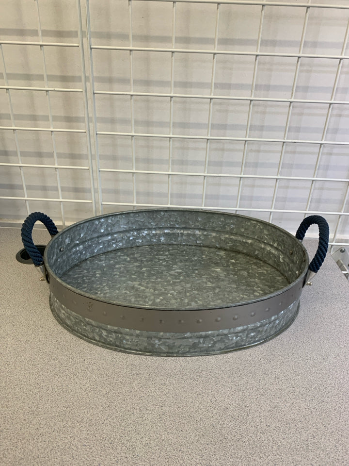 OVAL GALVANIZED METAL TRAY W/BLUE BRAID HANDLES.
