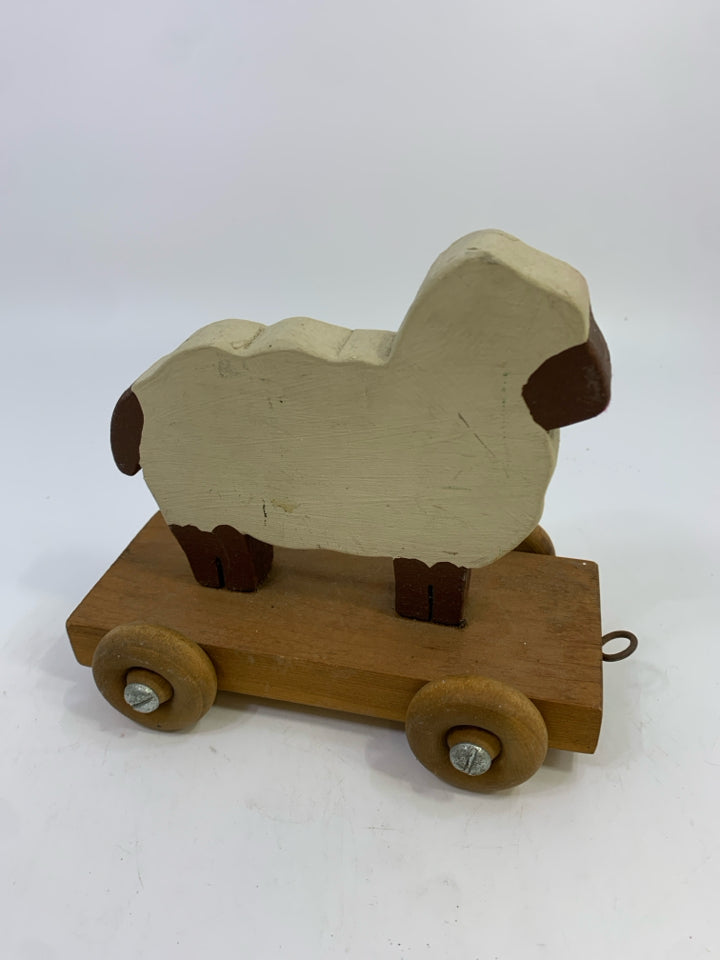 PRIMITIVE WOOD SHEEP ON WHEELS SHELF DECOR.