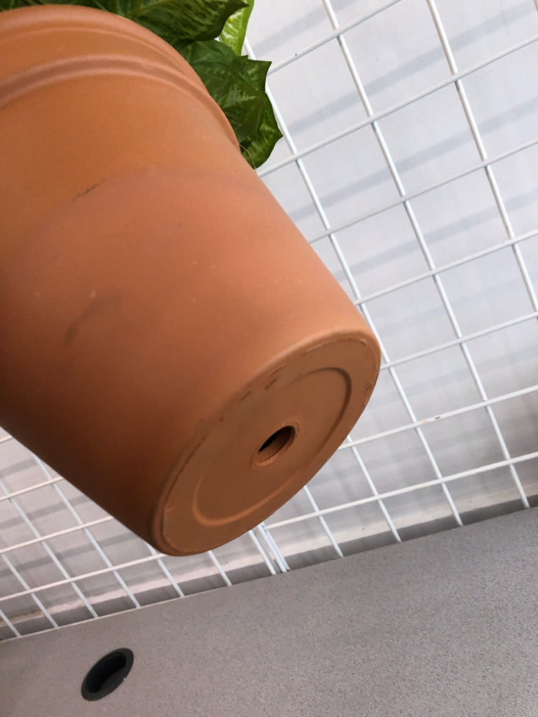 FAUX PLANT IN TERRA COTTA POT.
