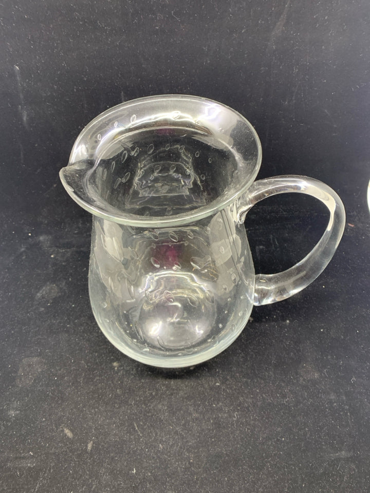 CLEAR GLASS PITCHER W/ CIRCLE DESIGNS.