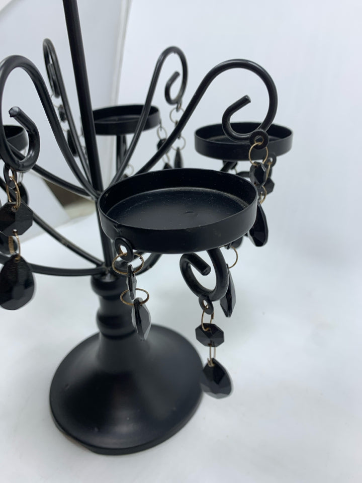 BLACK CANDLE HOLDER W/DANGLING GEMS.