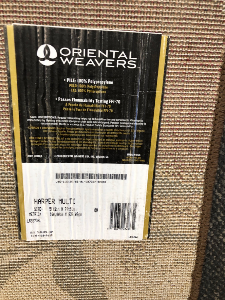 MULTICOLORED RUG W/LEAVES BROWN, RED & BLUE ORIENTAL WEAVERS.