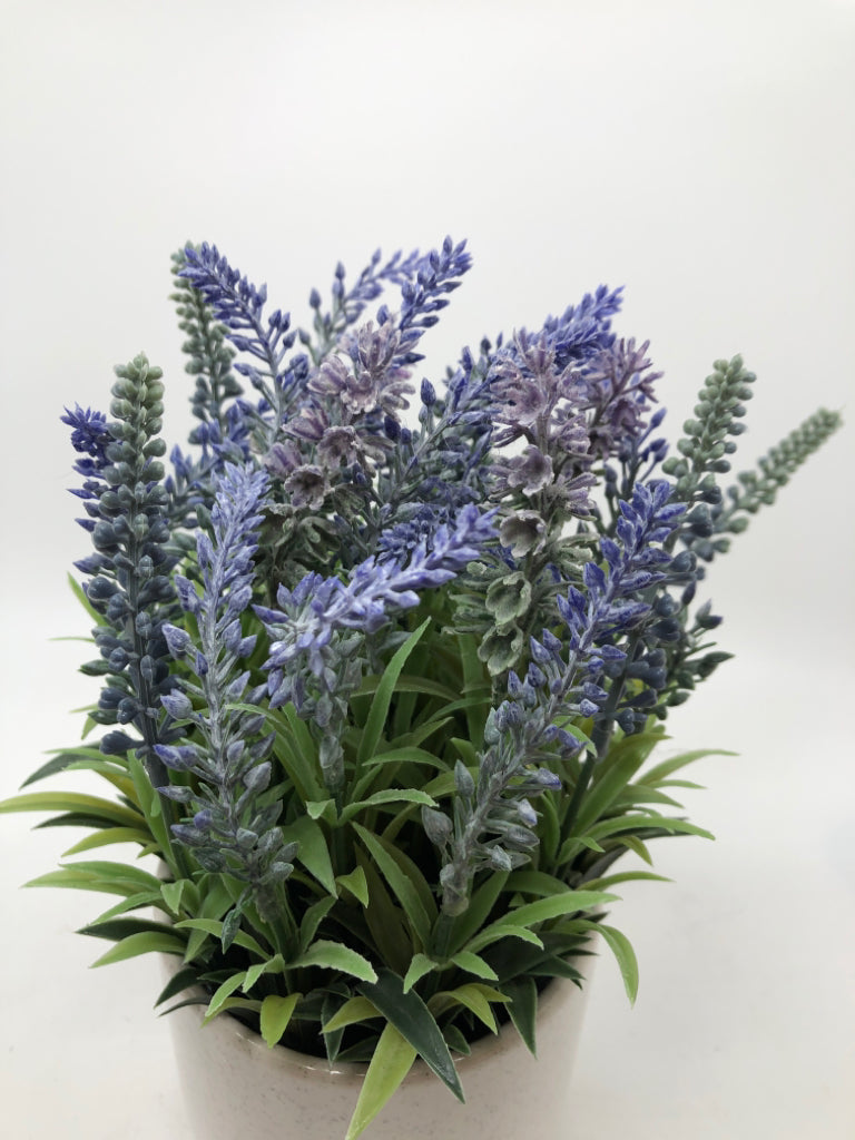 FAUX LAVENDER IN SPECKLED WHITE POT.