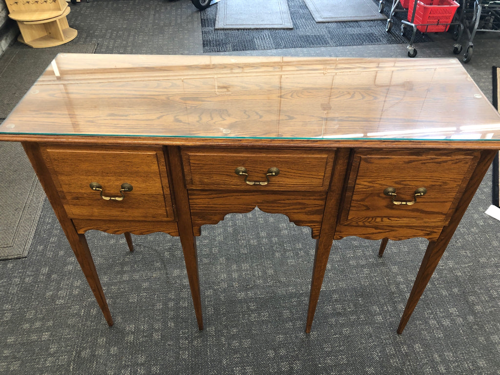 TALL WOOD BUFFET 3 DRAWER TABLE W/ GLASS TOP.