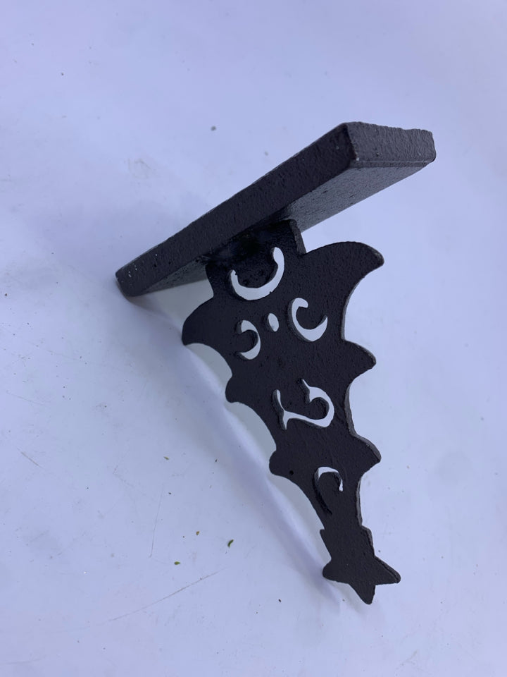 BROWN METAL CUTOUT TREE STOCKING HOLDER.