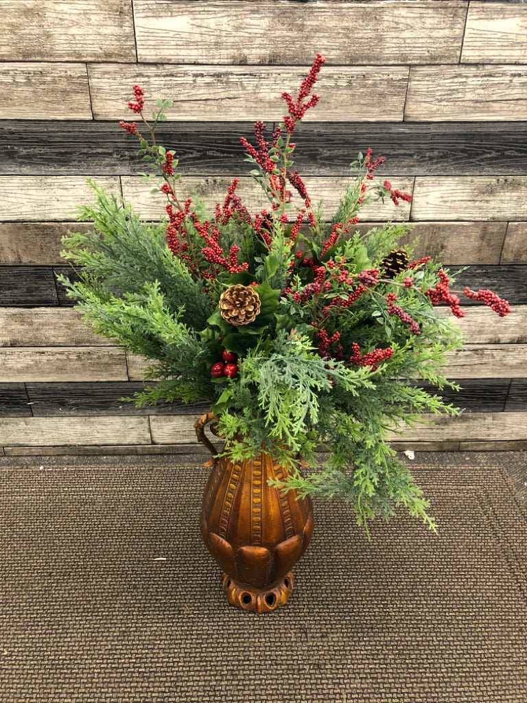 LG ORANGE/BRASS POT W/WINTER FAUX GREENS + PINECONES.