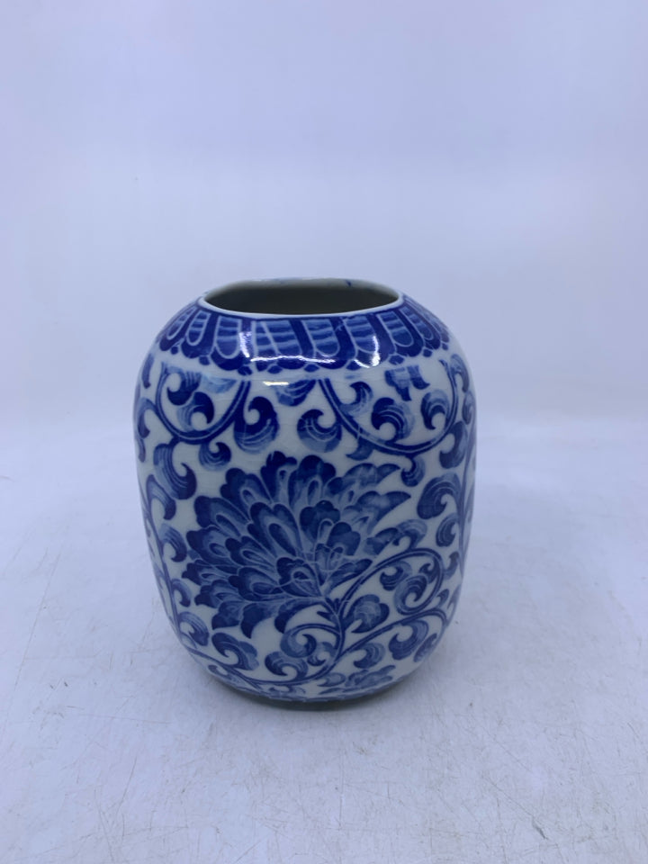 WHITE W/ BLUE FLORAL OVAL CERAMIC VASE.