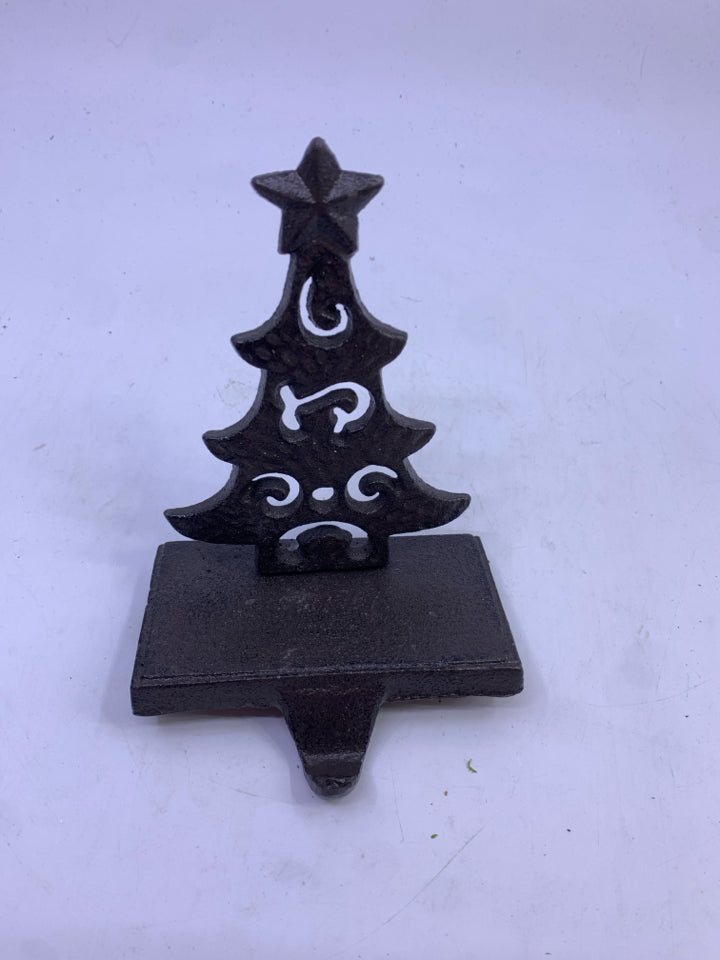 BROWN METAL CUTOUT TREE STOCKING HOLDER.