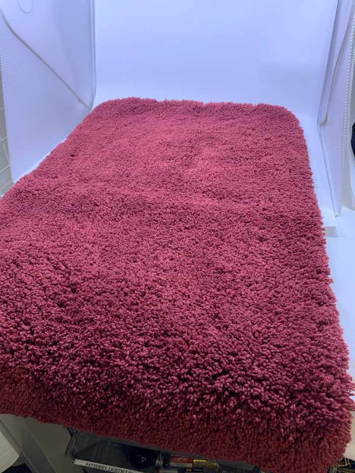 RED BATH MAT.