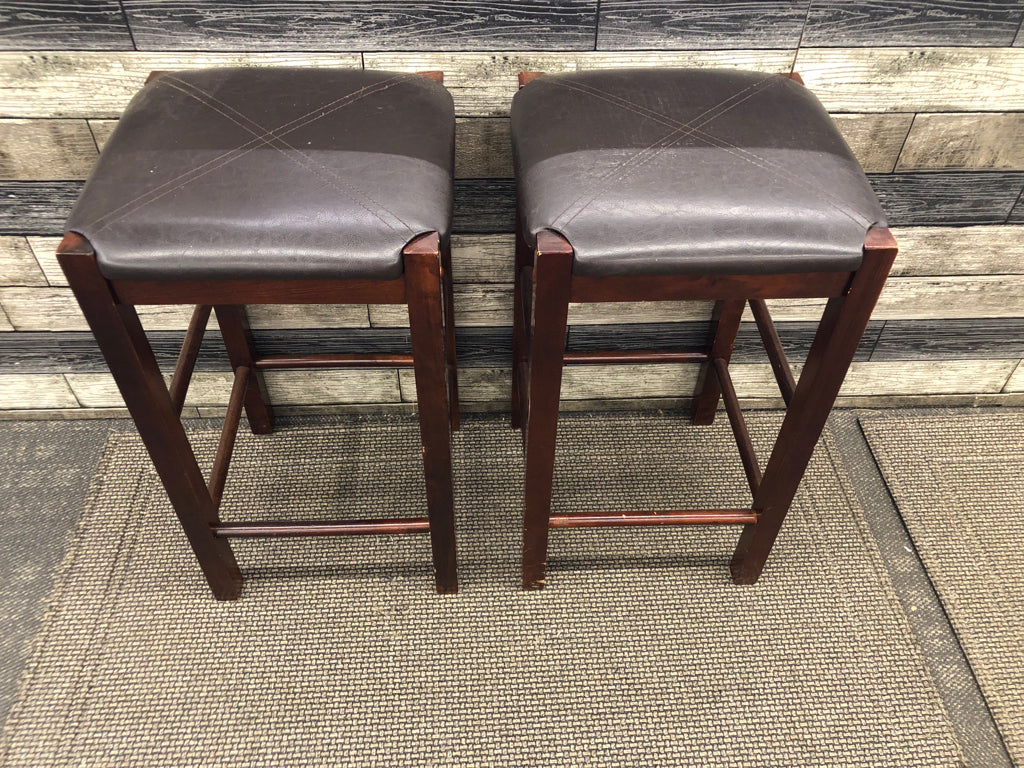 2 FAUX LEATHER UPHOLSTERED WOOD STOOLS.