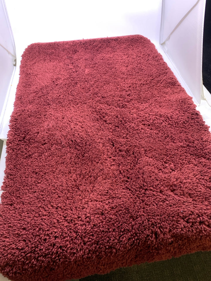 RED BATH MAT.