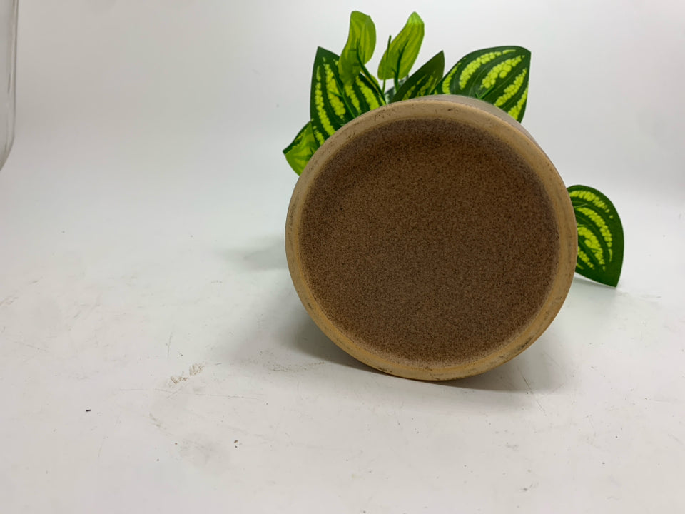 FAUX PLANT IN TAN CERAMIC POT.