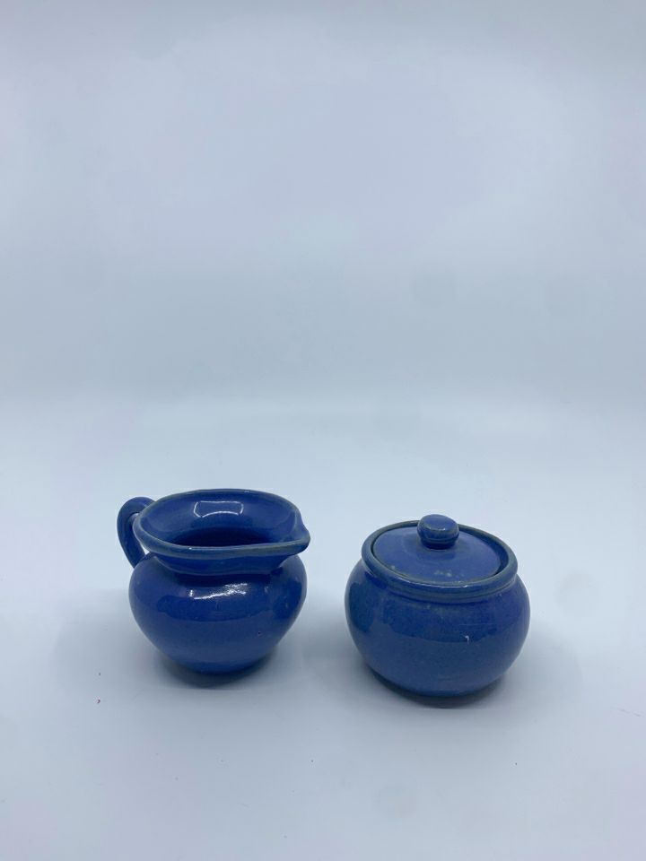 SMALL BLUE POTTERY CREAMER + COVERED SUGAR.