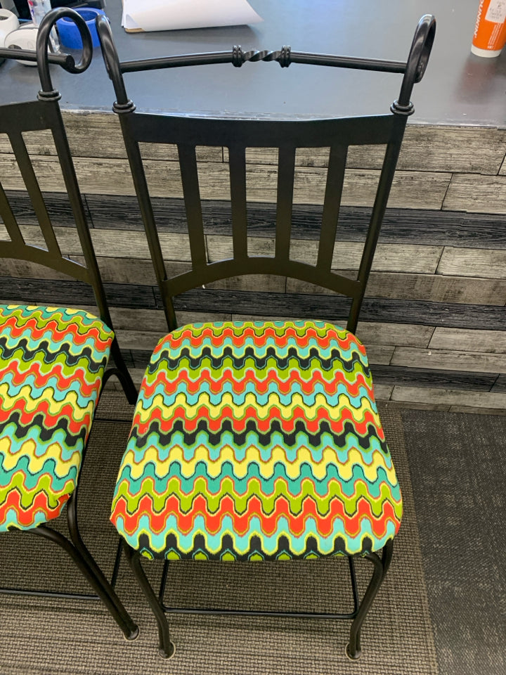 3 METAL SCROLL BAR STOOLS W/COLORFUL UPHOLSTERED SEAT.