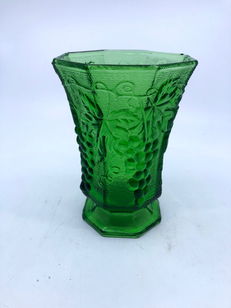 GREEN GLASS FOOTED  HEXAGON VASE W/ EMBOSSED GRAPES.