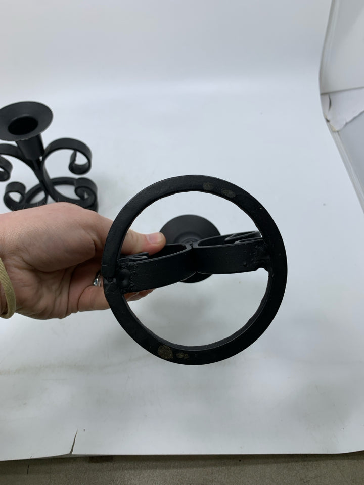 2 BLACK METAL SCROLL TAPERED CANDLE HOLDERS.