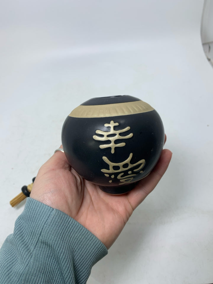 SMALL GINGER JAR W/ STICKS THROUGH TOP & SYBOLS.