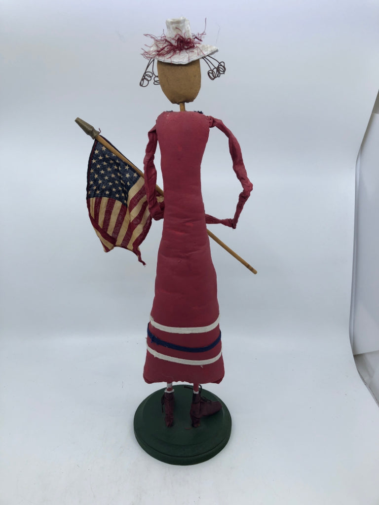 PRIMITIVE WOMAN HOLDING FLAG.