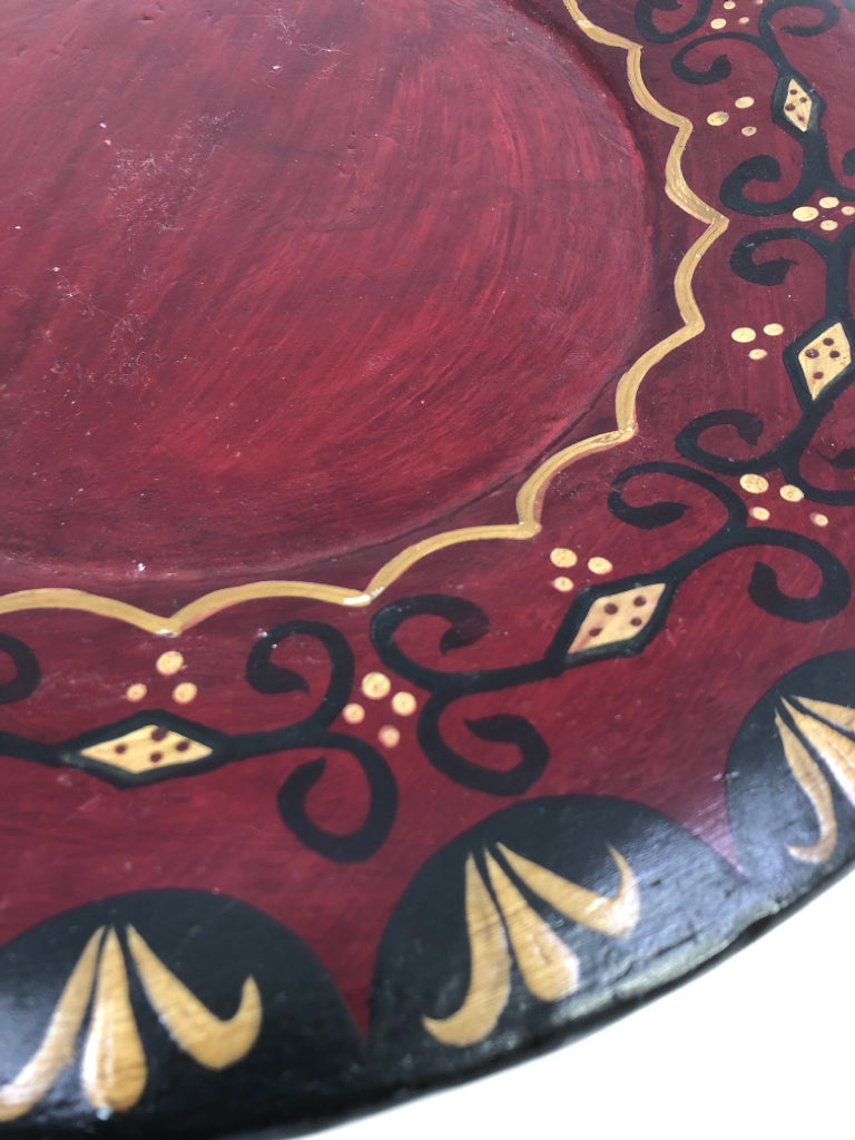 PRIMITIVE WOOD DECORATIVE PLATE RED W/GOLD AND BLACK ACCENTS.