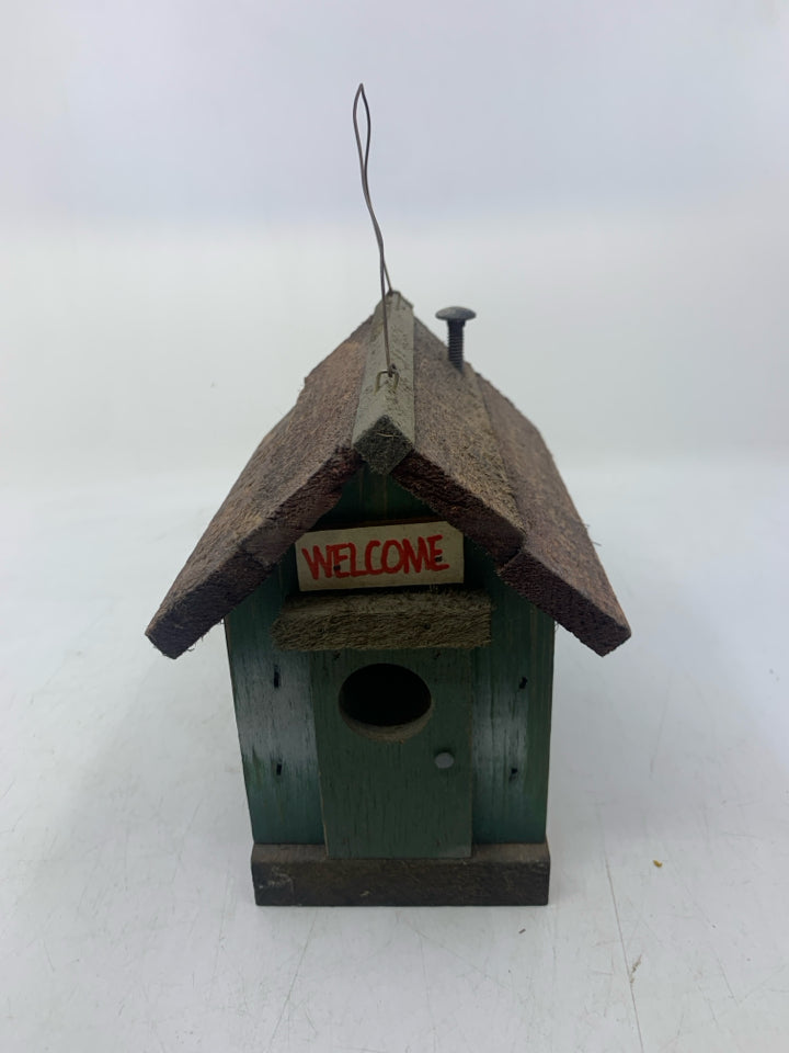 DISTRESSED GREEN CABIN W/ WINDOWS.