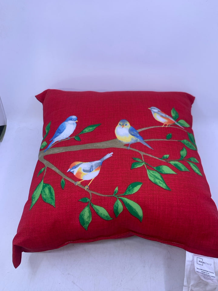 RED PILLOW W/ BLUE BIRDS ON BRANCH.