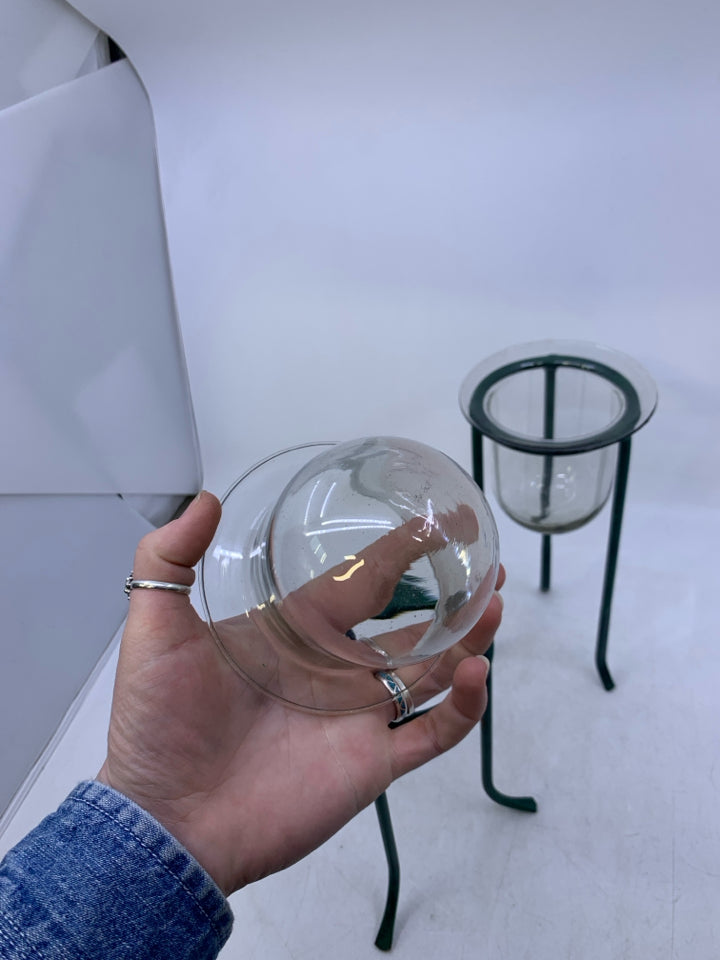 2 GREEN METAL STANDS W/ GLASS INSERTS.