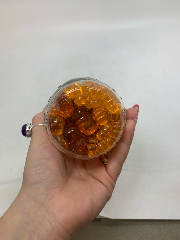 JAR OF PUMPKIN BEADS.