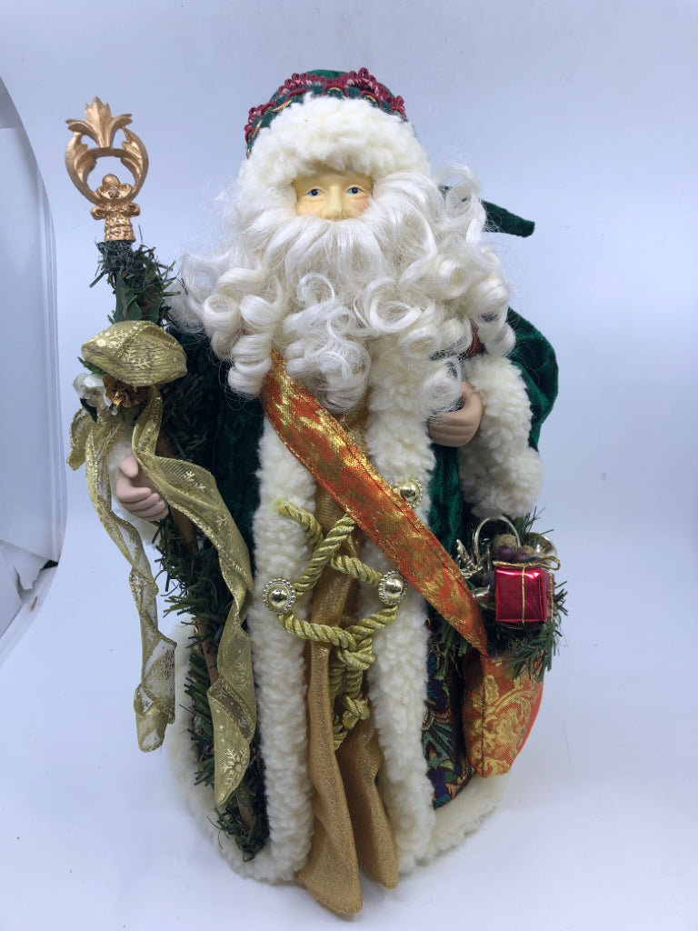 STANDING HOLLOW SANTA W/ DARK GREEN JACKET HOLDING STAKE.