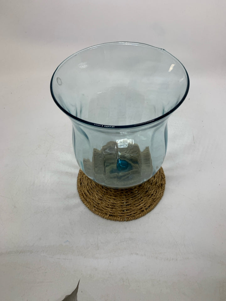 BLUE TINTED GLASS W/ WOVEN BASE CANDLE HOLDER.