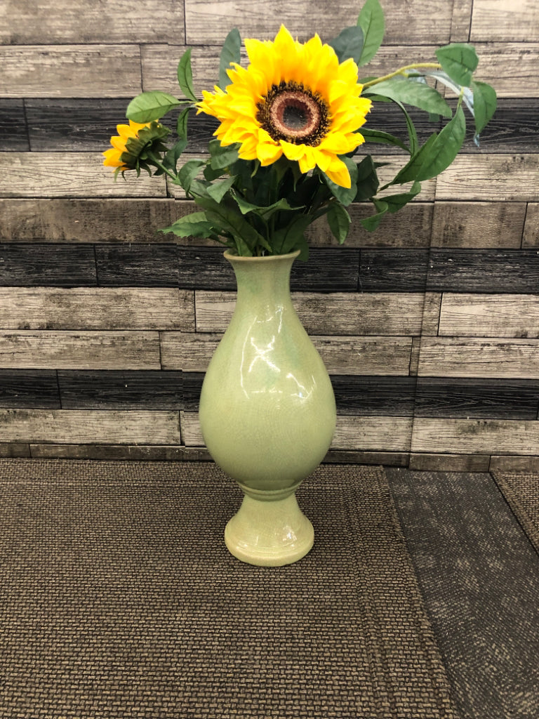 FAUX FLOWERS IN LARGE GREEN VASE.