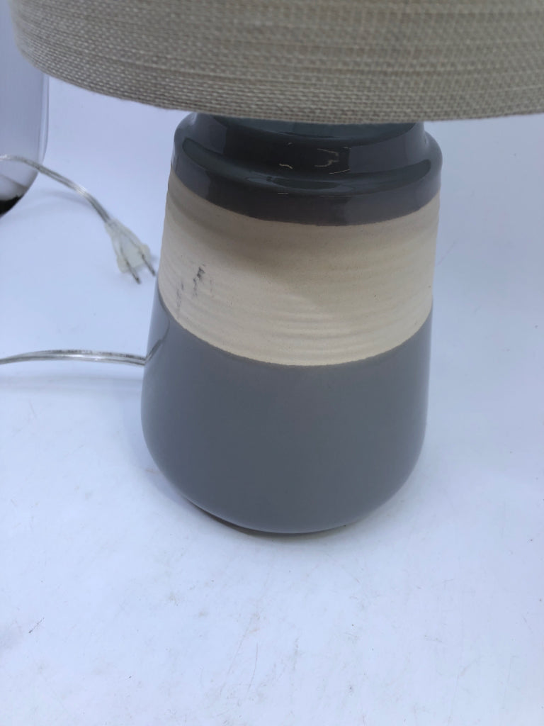 GREY/CREAM CERAMIC BASE LAMP W/TAN SHADE.