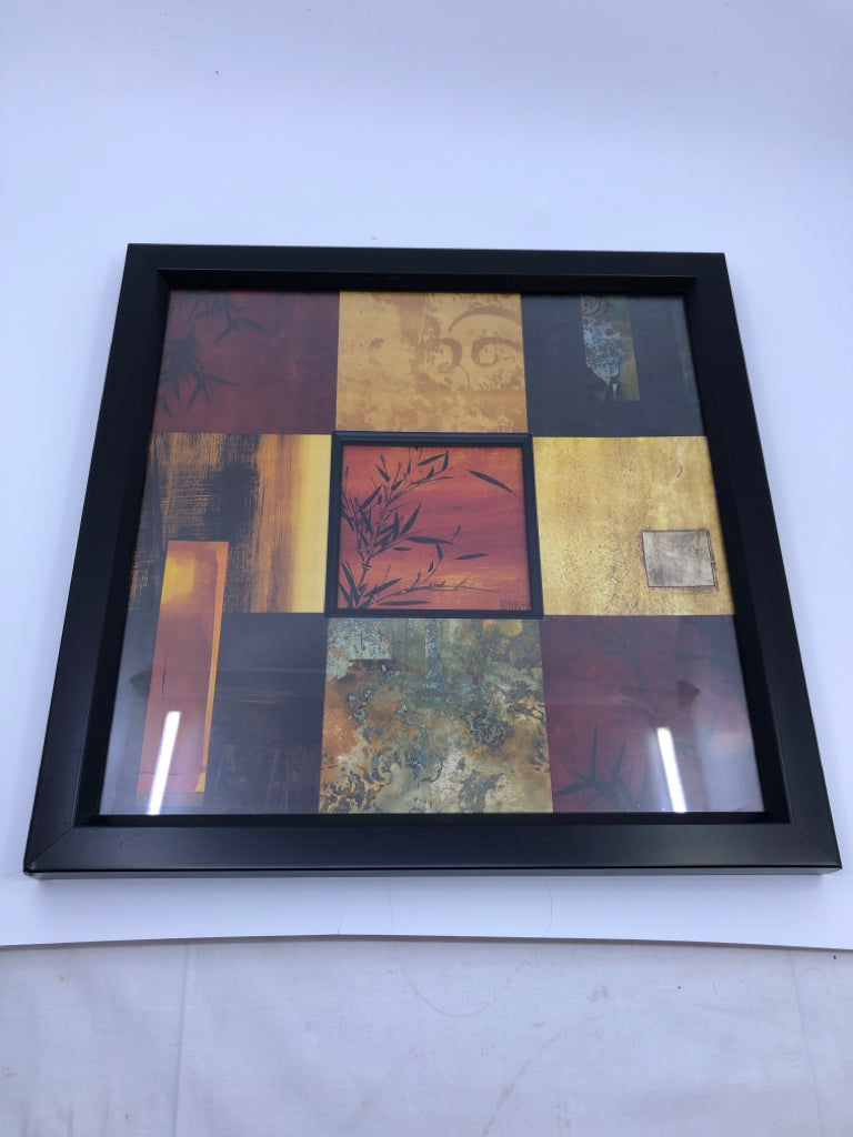 RED SQUARE PATTERN W BLACK LEAVES WALL ART IN BLACK FRAME.