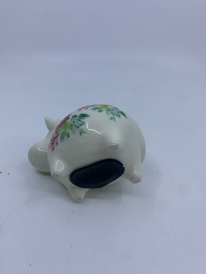 COW PIGGY BANK WITH RED FLOWERS.