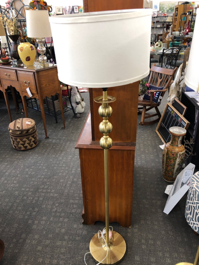 GOLD METAL BASE FLOOR LAMP W/ WHITE SHADE.