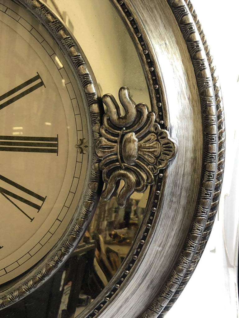 PLASTIC SILVER CLOCK W/ MIRRORS.