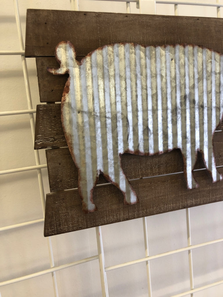 GALVANIZED METAL PIG ON WOOD SLATS.