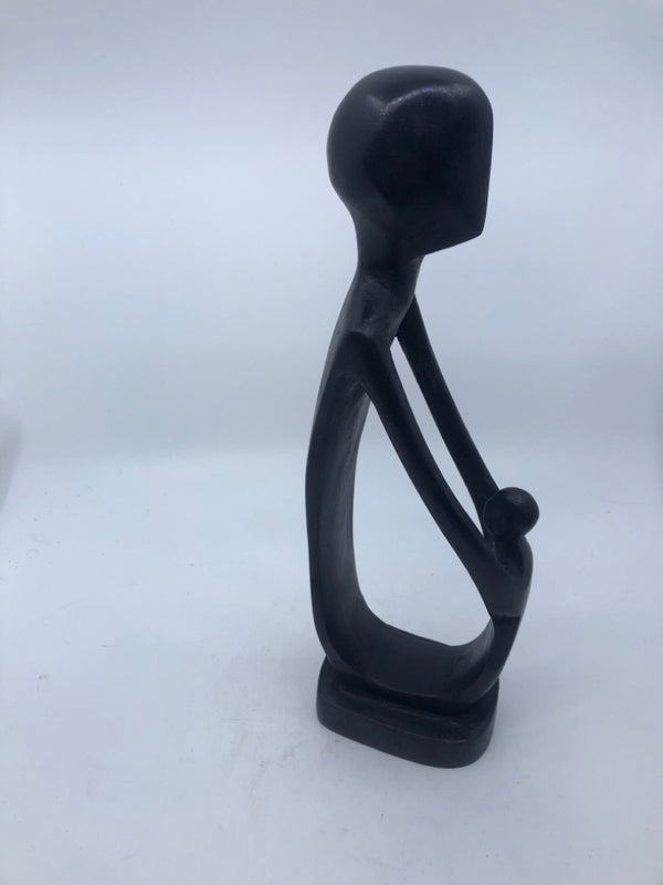 BLACK CARVED ART FORM MAN/CHILD HOLDING HANDS.