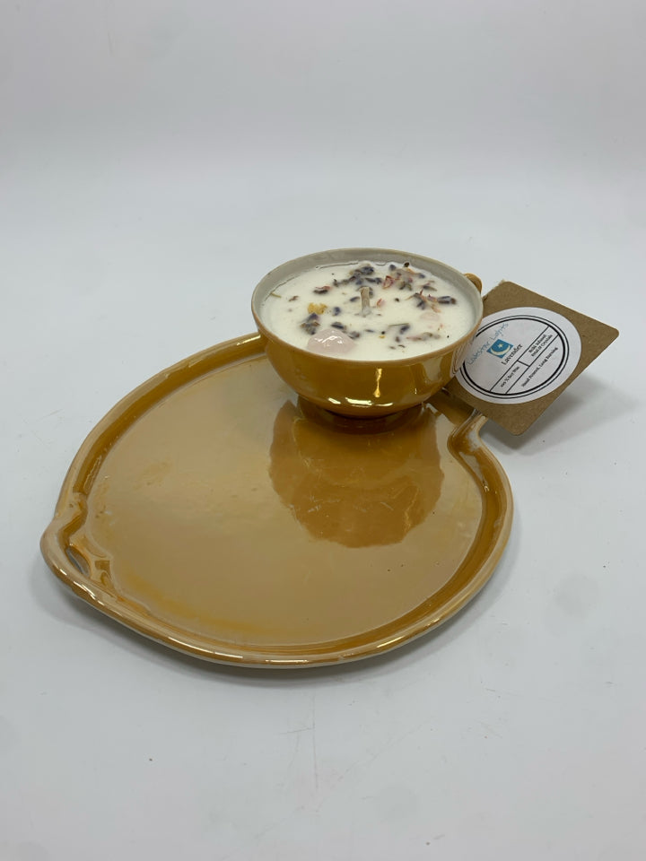 LAVENDER CANDLE CUP ON PEACH IRIDESCENT TRAY.