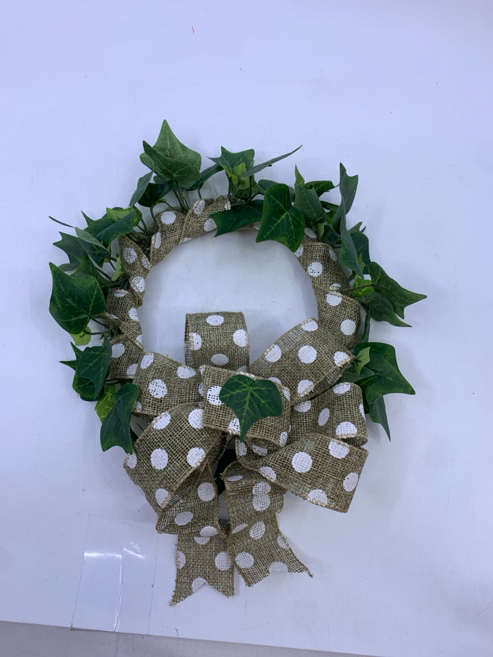 GREEN IVY WREATH WITH POLKA DOT RIBBON.