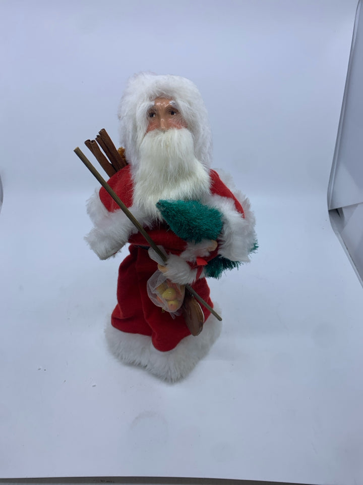 1990 BYERS CHOICE SANTA HOLDING SACK OF TOYS.