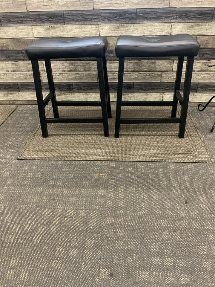 2 SADDLE BLACK FAUX LEATHER BAR STOOLS.